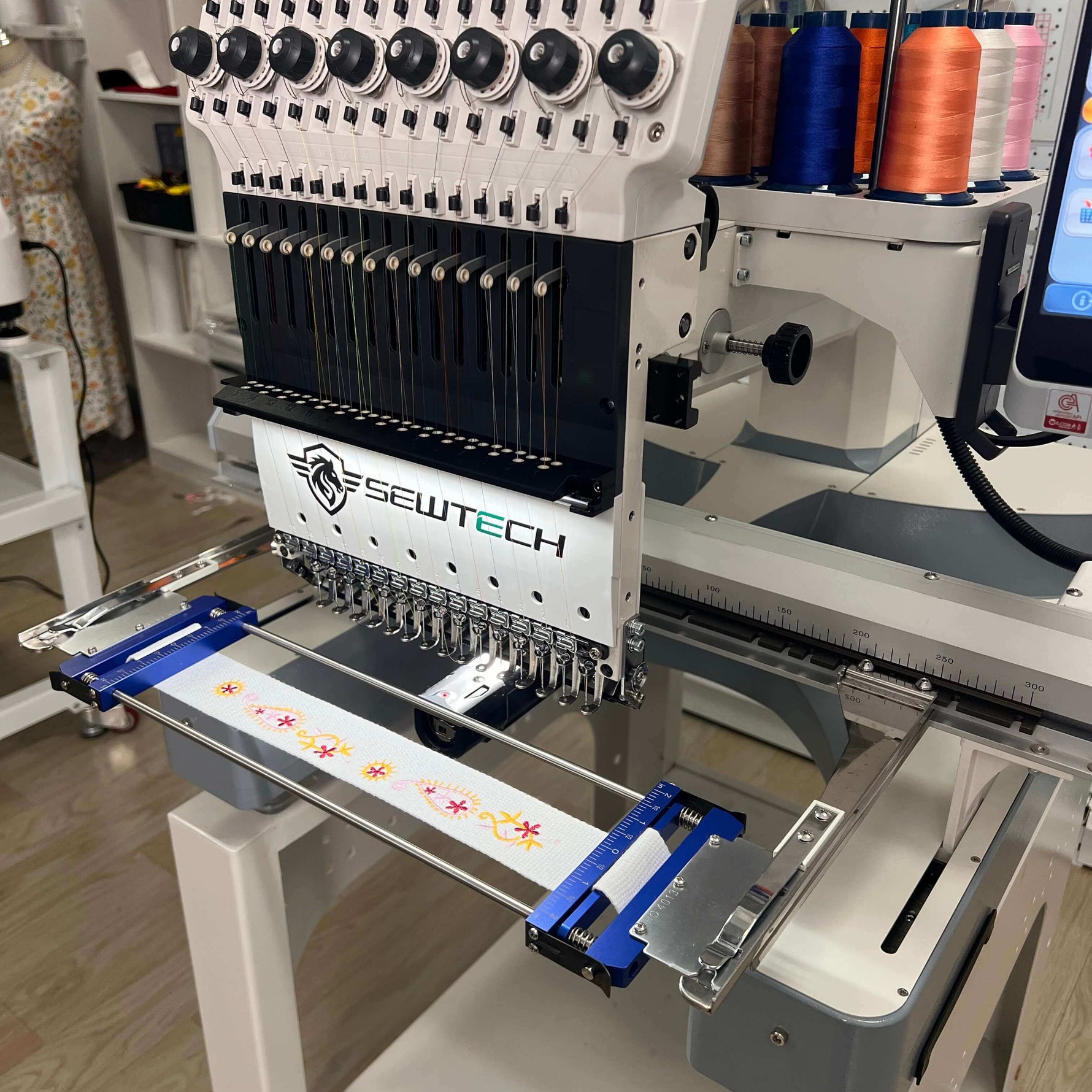 Hoop installed while stitching a long tape — BAI embroidery machines, 2.6×11.8 in